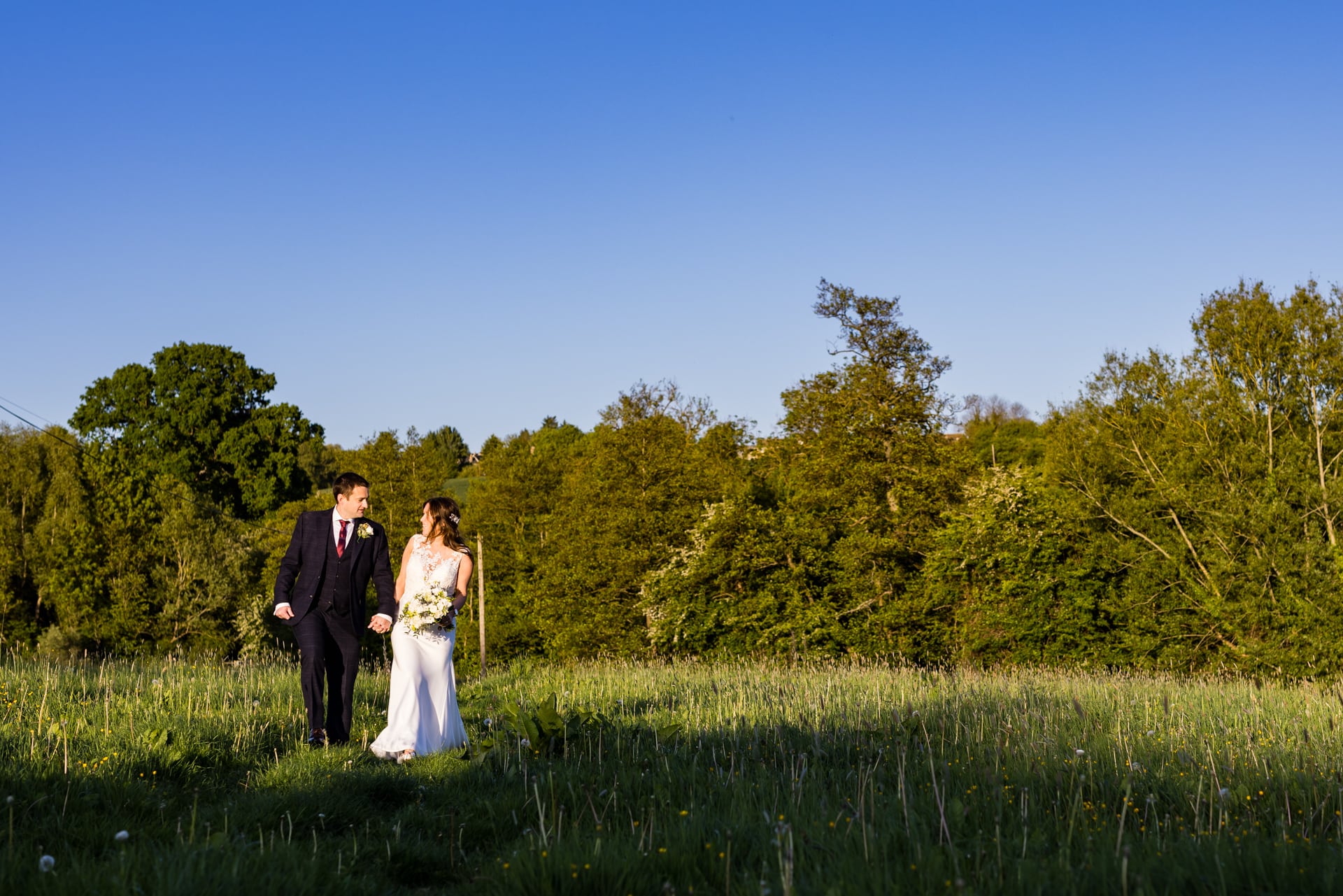 wedding couple walking in the field