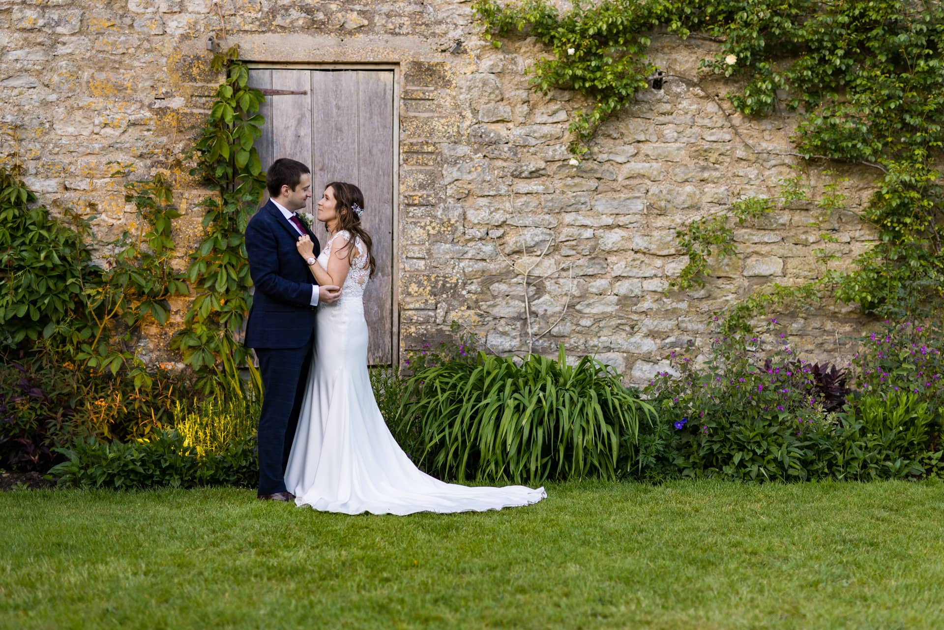 Wedding Couple outside old barn in the grounds of Priston Mill Wedding Venue