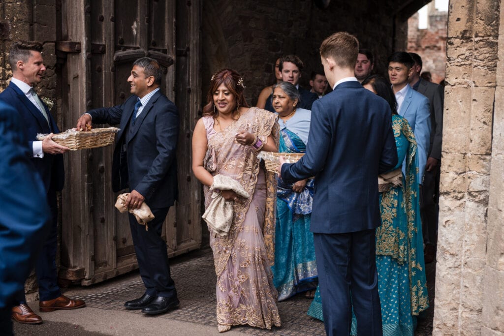 Wedding guests collecting confetti