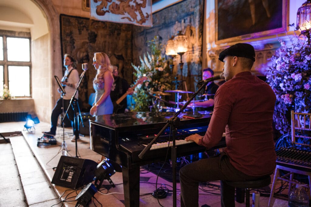 Guy playing the keyboard as part of a band