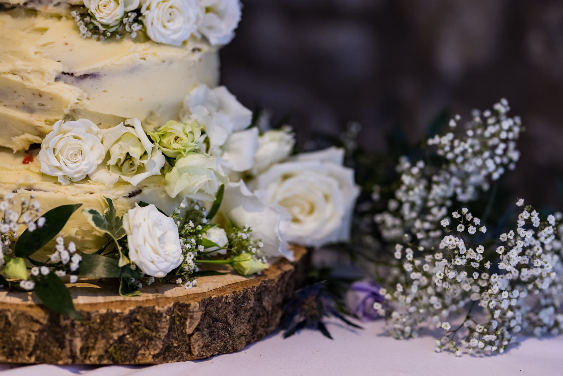Wedding cake details with flowers in the barn at Priston Mill Wedding Venue