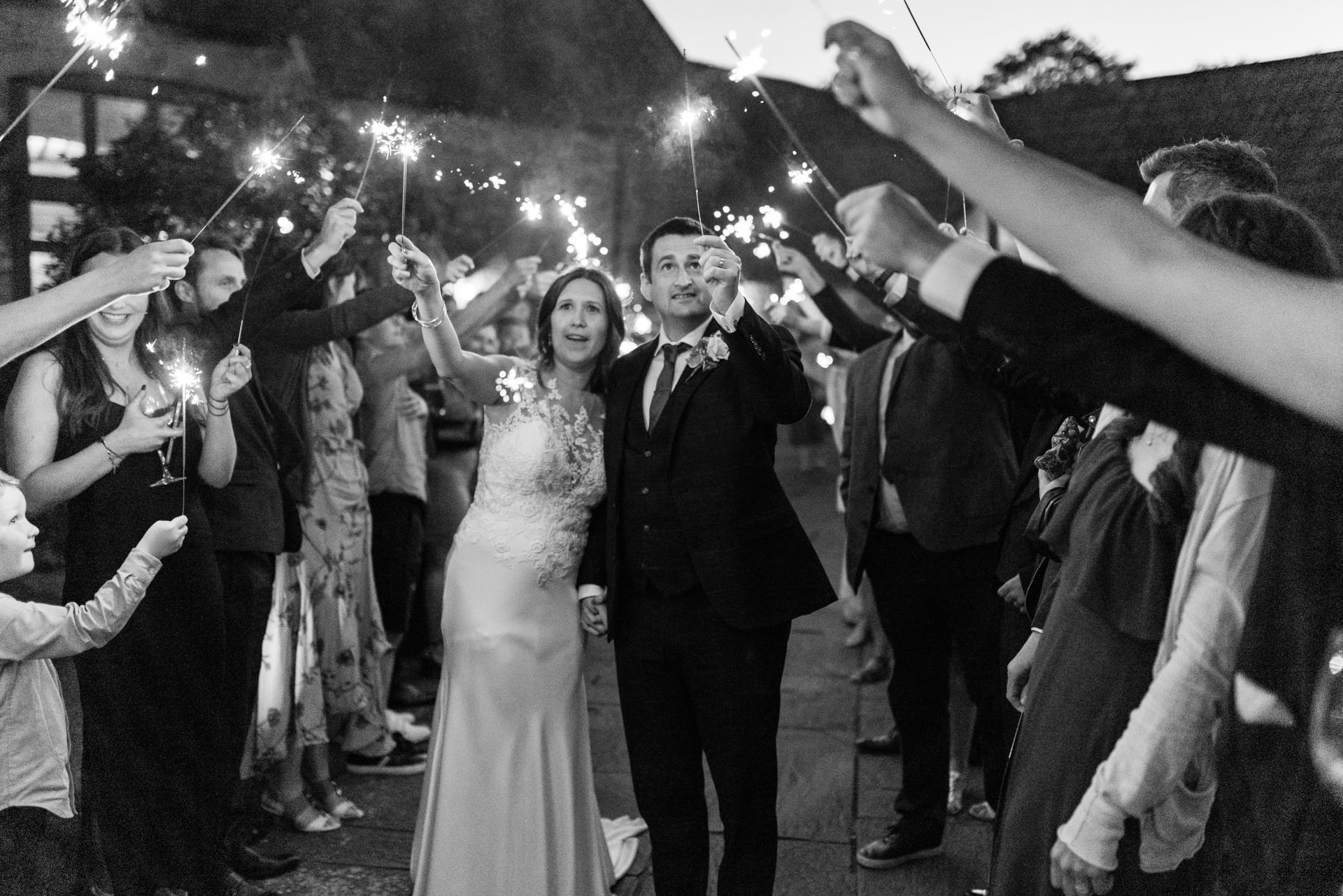 black and white wedding sparklers walk at Priston Mill Wedding Venue