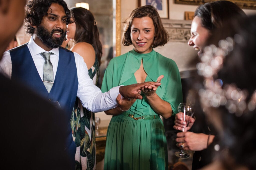 Groom showing his wedding band to guests