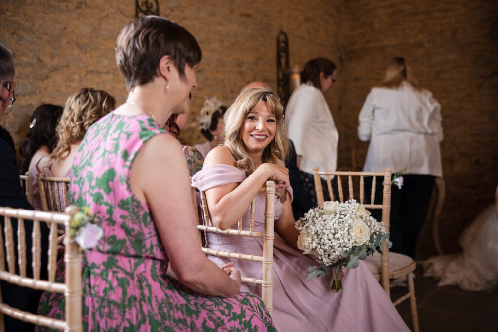 Bridesmaid looking at ceremony