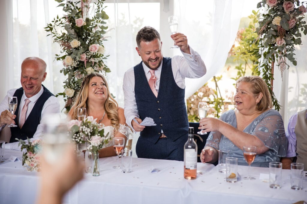 Groom toasting at reception