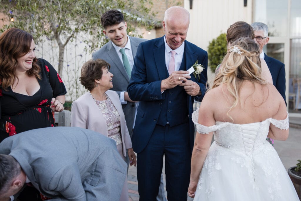Wedding family at the photobooth looking at images