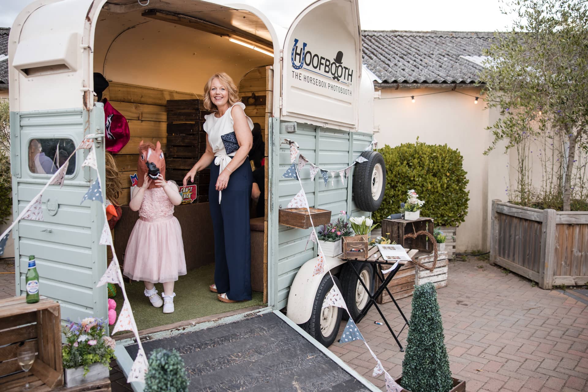 Horsebox photobooth with small child wearing horse hat at Stratton Court Barn Wedding Venue