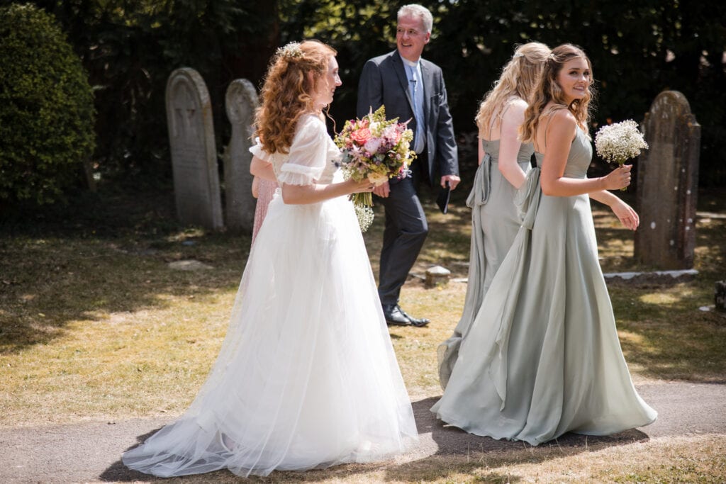 Bride and Bridesmaids entering the churchyard