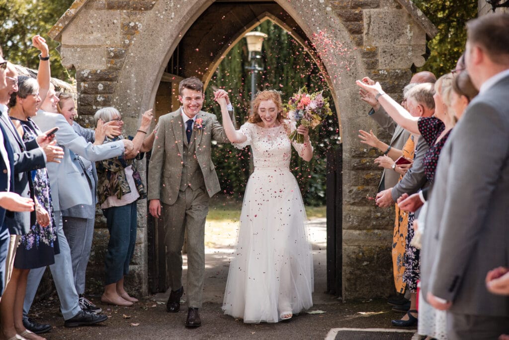 Bride and Groom walking into confetti