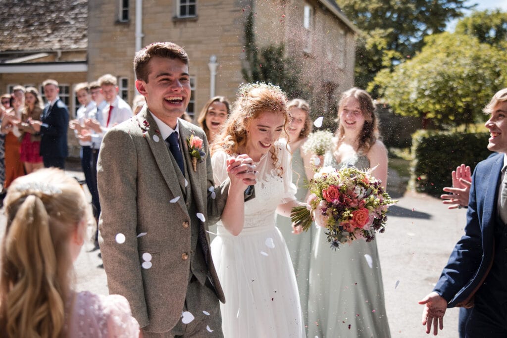 Bride and Groom laughing during confetti line walk