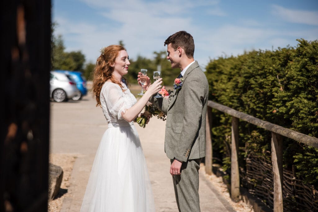 Bride and Groom sharing first glass of Champagne