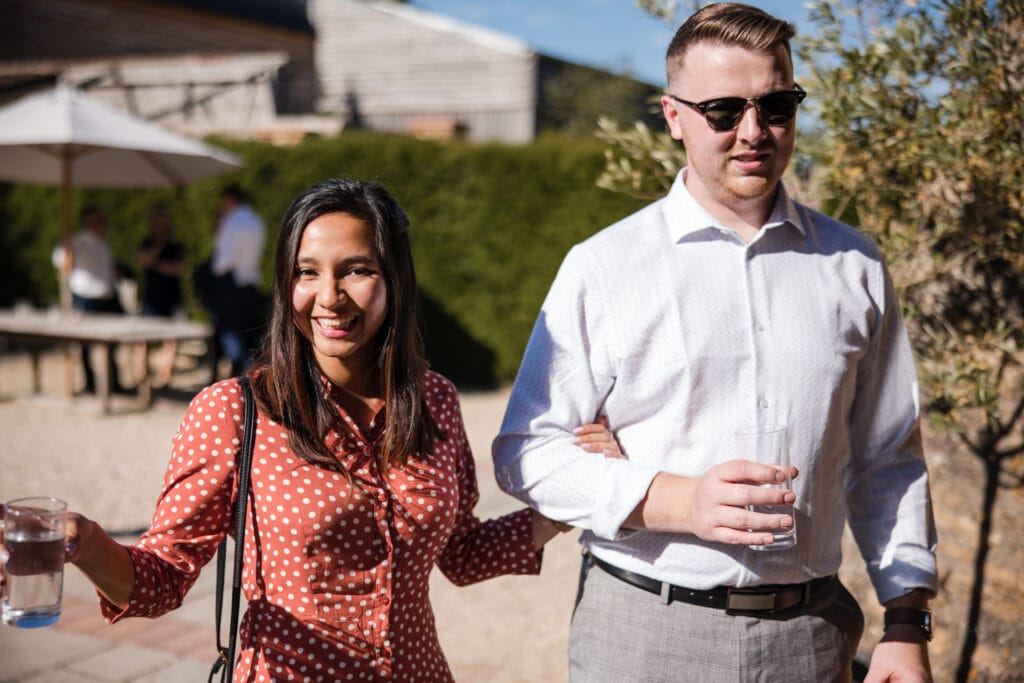 Wedding Guests having a drink in the courtyard of the barn