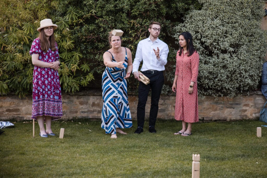 Wedding guests playing games in the Oxleaze Barn garden