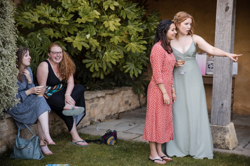 two pairs of wedding guests in the gardens