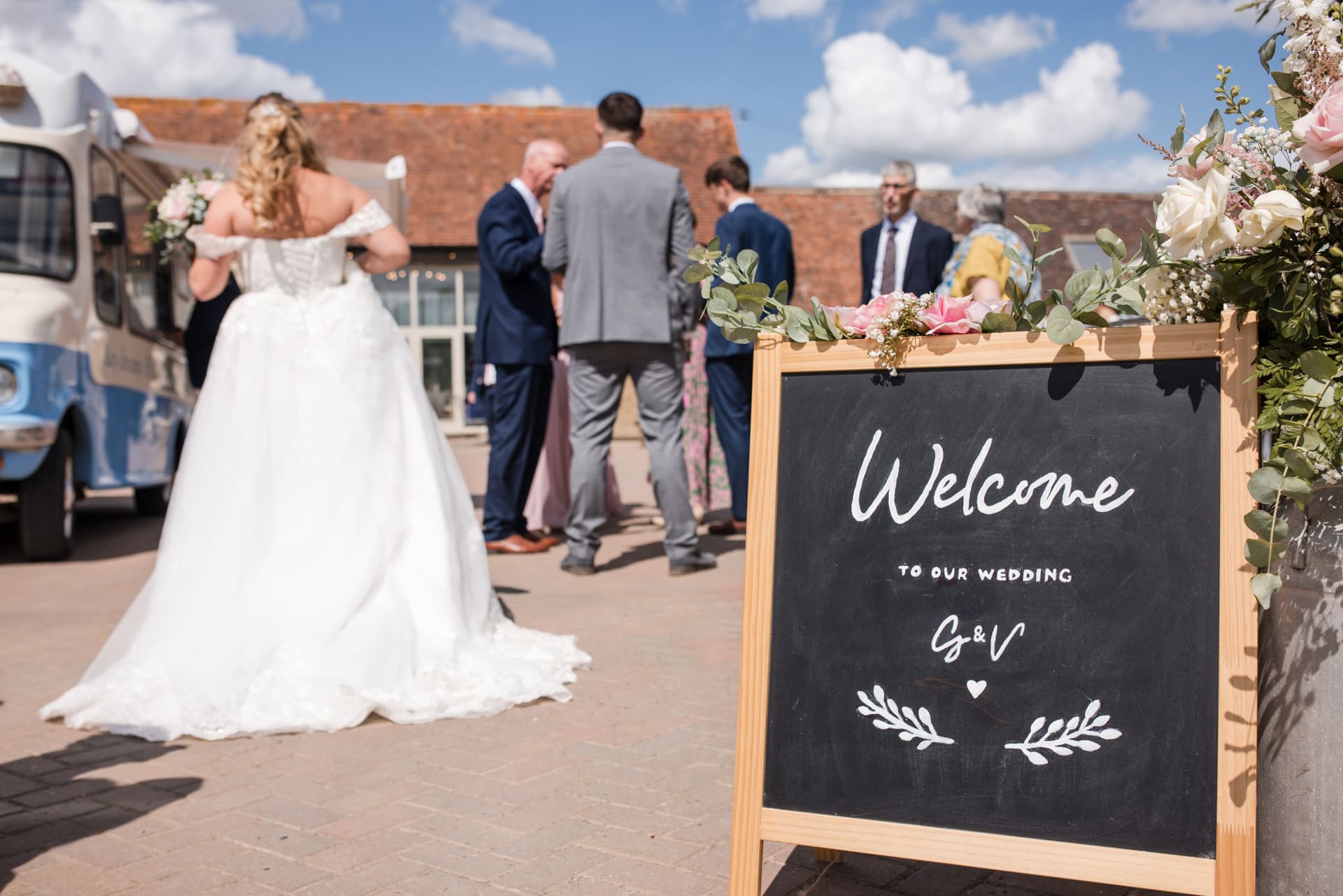 Welcome sign with Bride in background