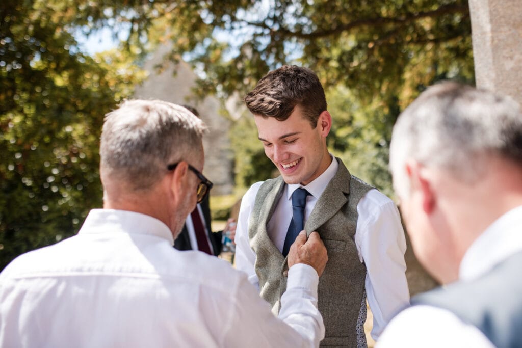Grooms waistcoat being adjusted