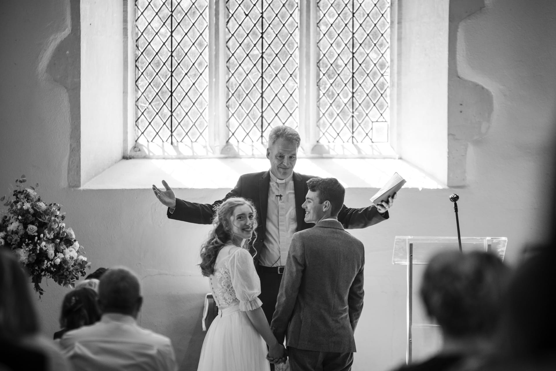 Vicar Ceremony whilst Bride looks over her shoulder