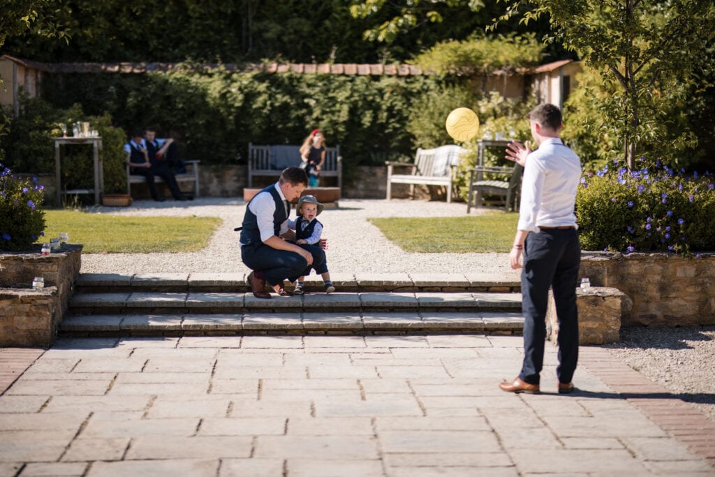 Baby watching a yellow ball being bounced