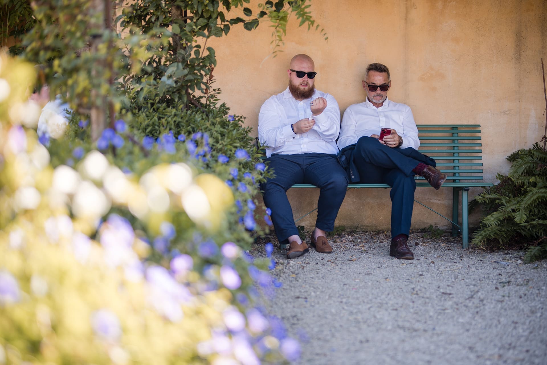 Two men sat in the shade with sunglasses on at Oxleaze Barn