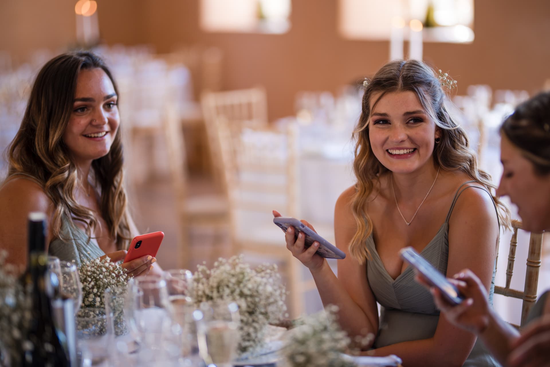 Bridesmaids comparing notes on mobile phones
