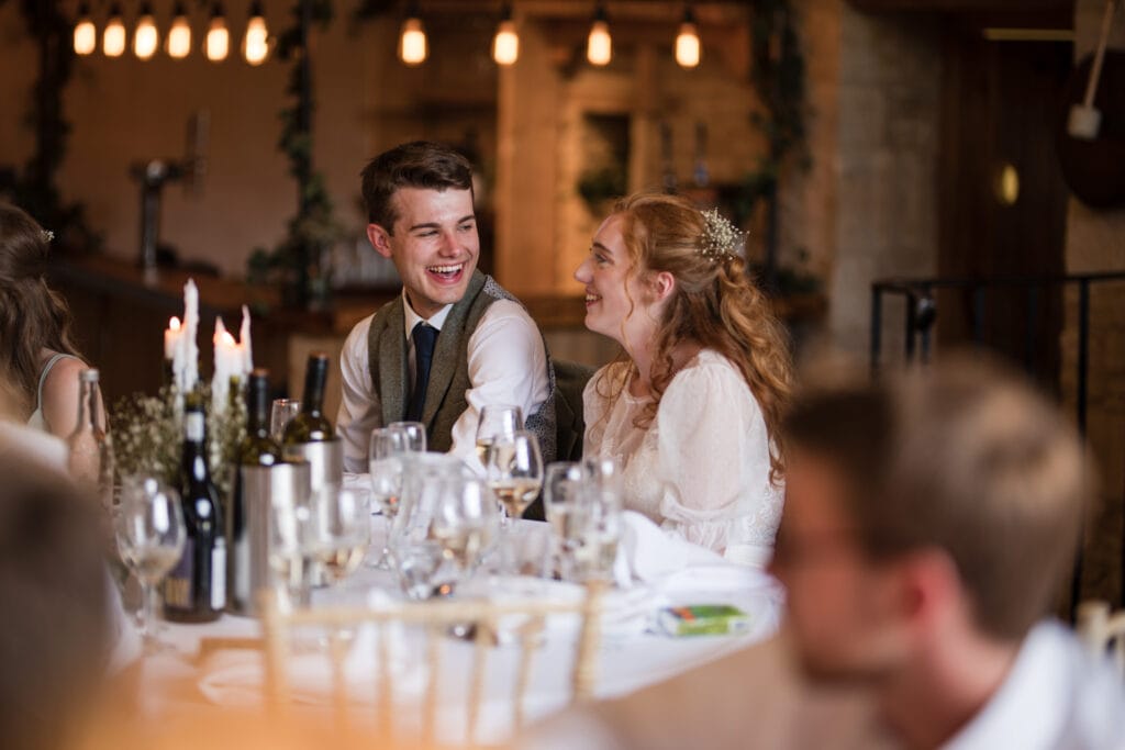 Bride and Groom laughing during speeches