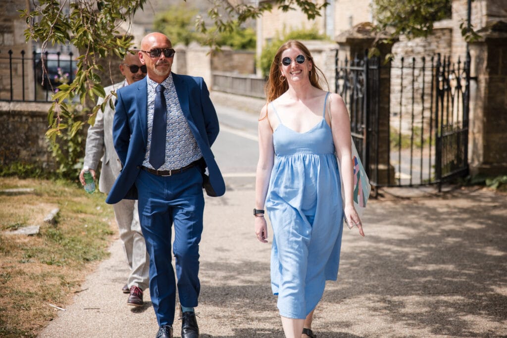 Guests arriving at church. Burford Wedding, Oxleaze Barn