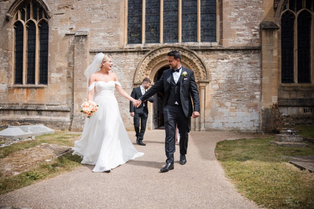 Bride and Groom just married walk outside church