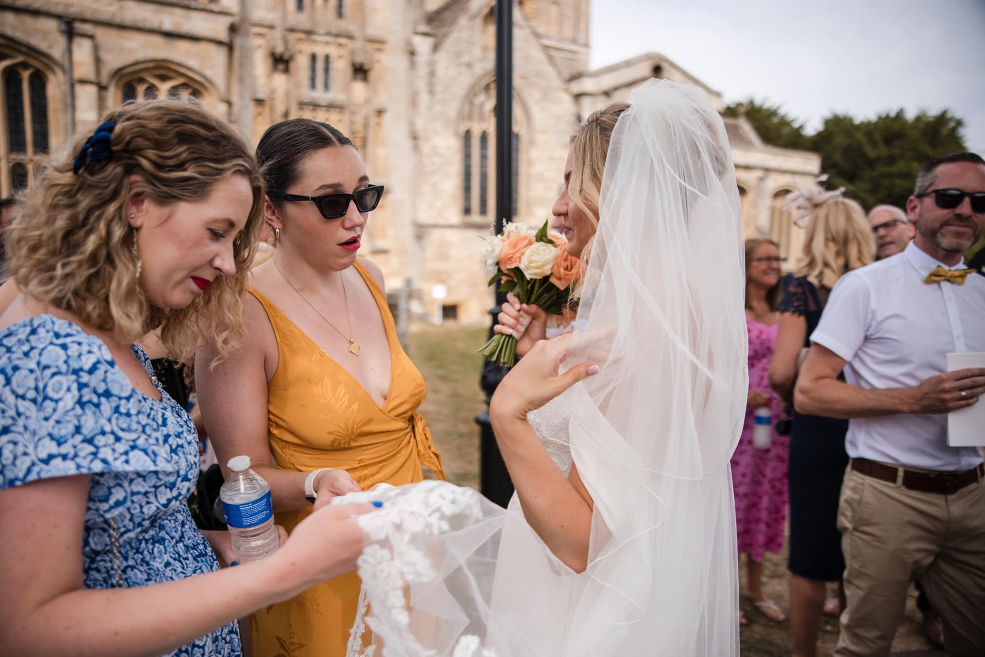 Bride chatting to friends outside the church