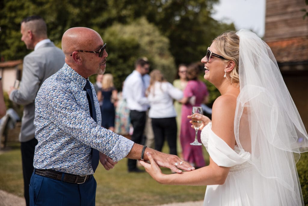 Bride and Guest in the Courtyard at Oxleaze Barn
