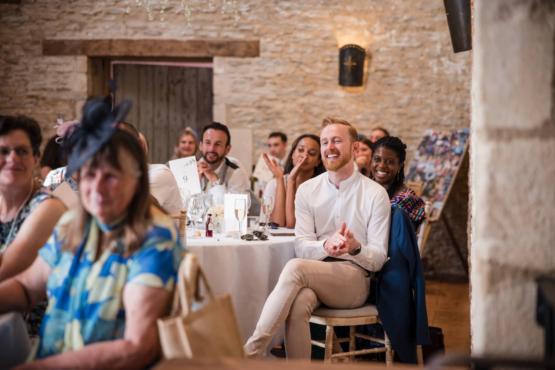 Wedding guests during speeches at Oxleaze Barn