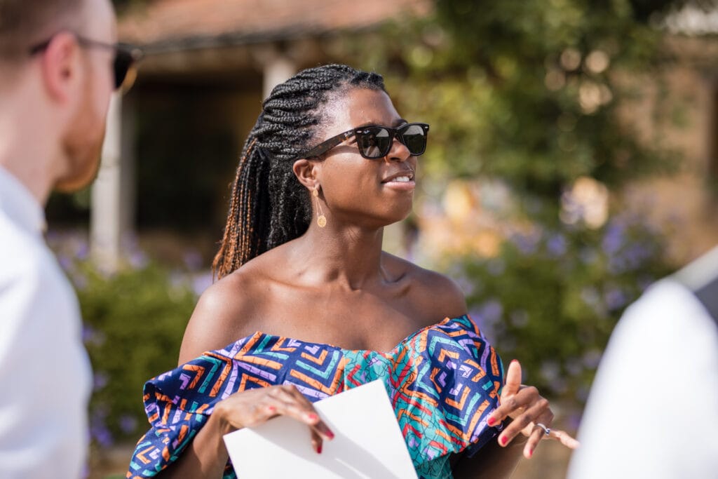 Lady in shades and colourful dress at Oxleaze Barn