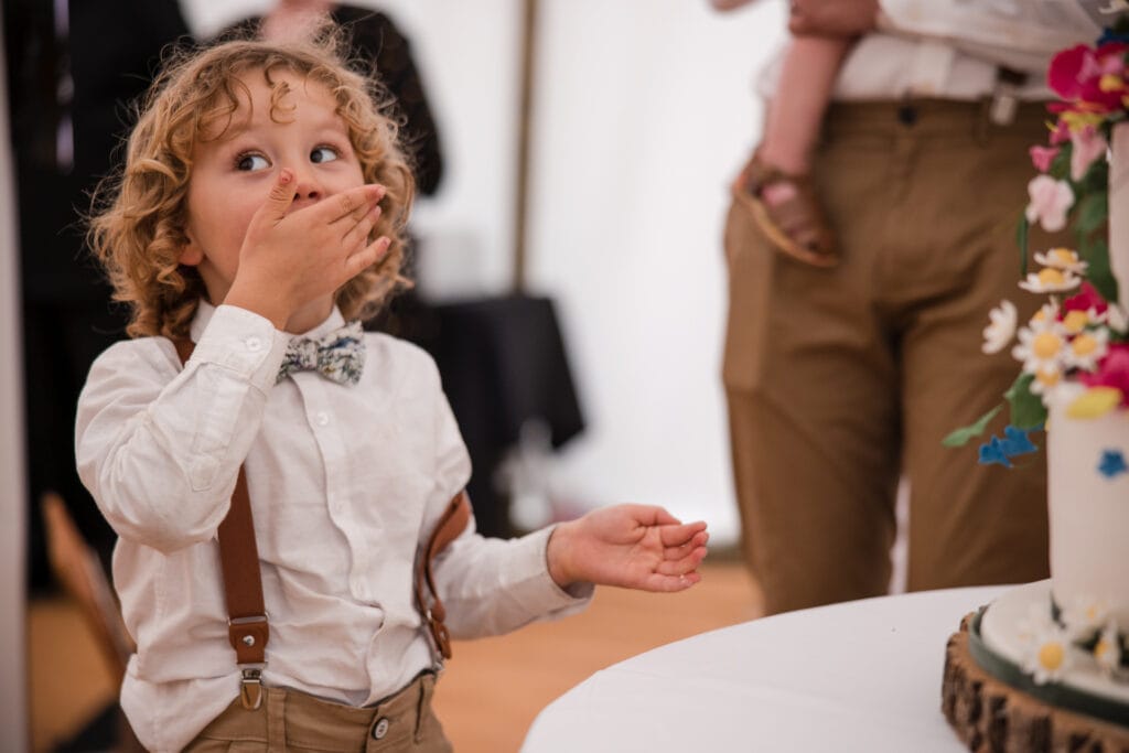 Son of Groom eating the wedding cake
