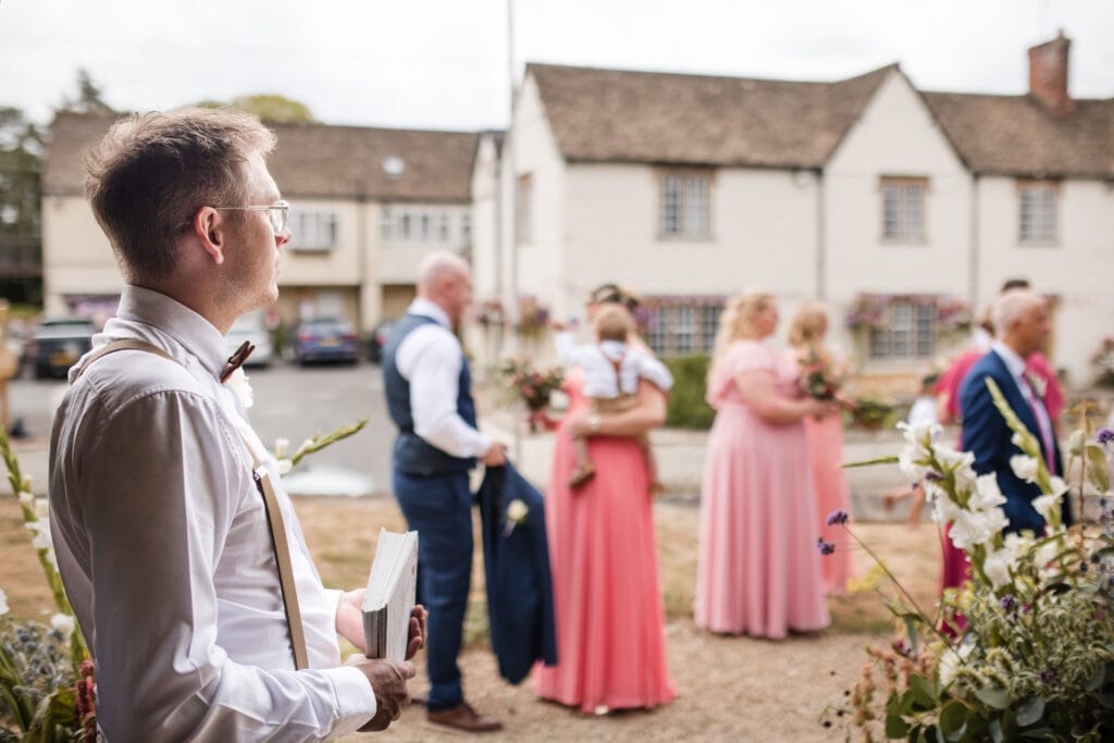 Groomsman looks on outside the Church