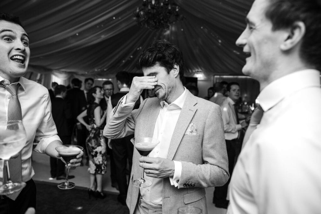 Guests drinking an expresso martini at Notley Tythe Barn Wedding