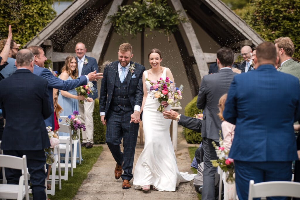 Outside Wedding confetti shot at Kingscote Barn