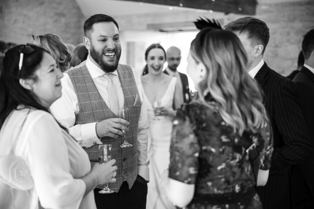 Guests talking inside Kingscote Barn