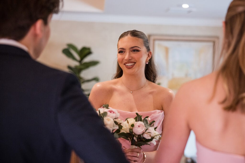 Bridesmaid talking to family at Le Manoir