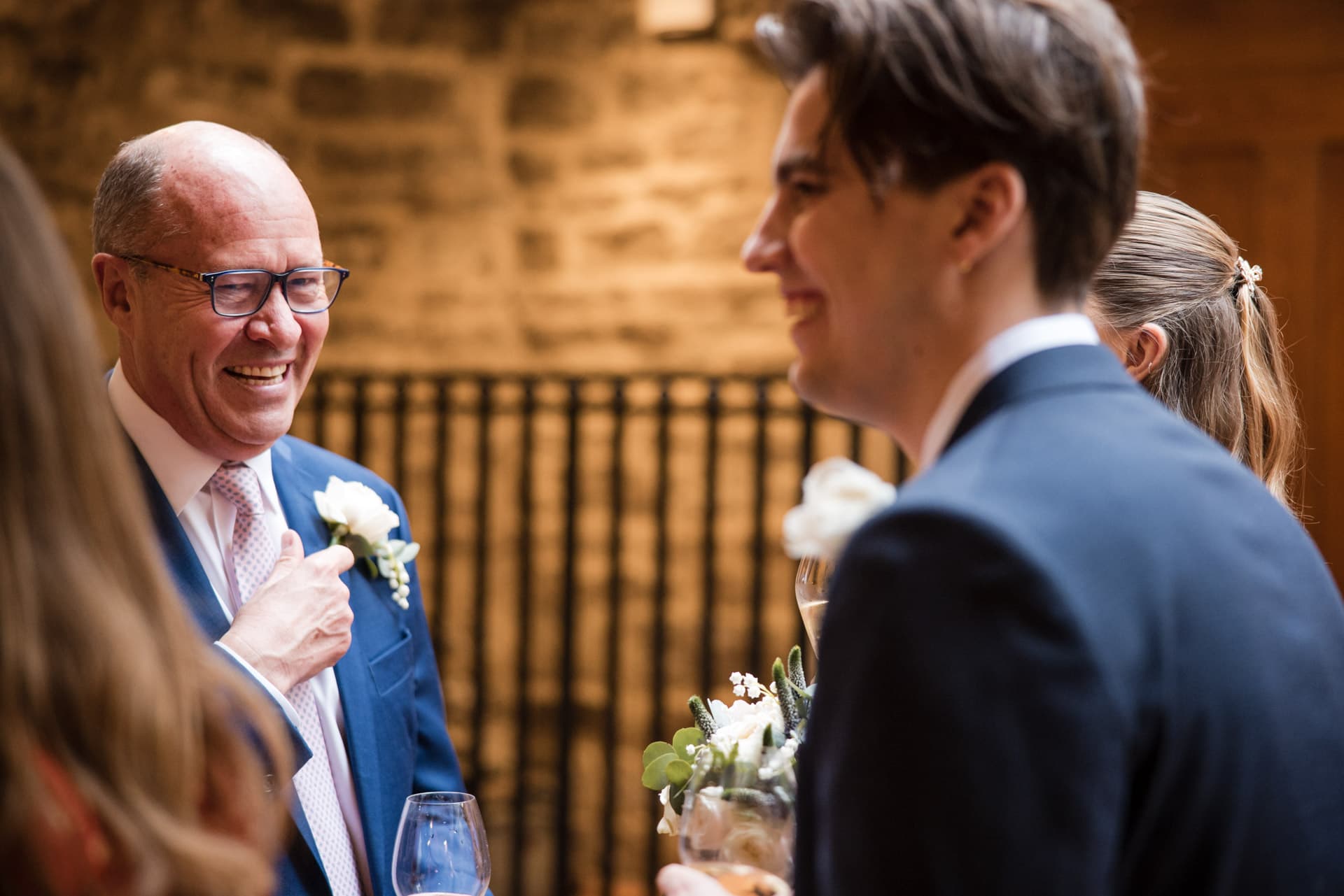 Groom laughing with family at Le Manoir