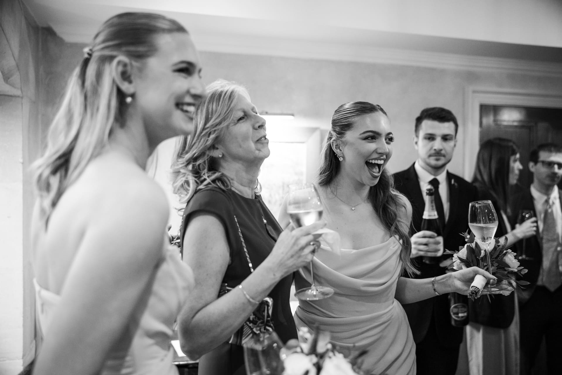 Bridesmaid laughing with guests at Le Manoir
