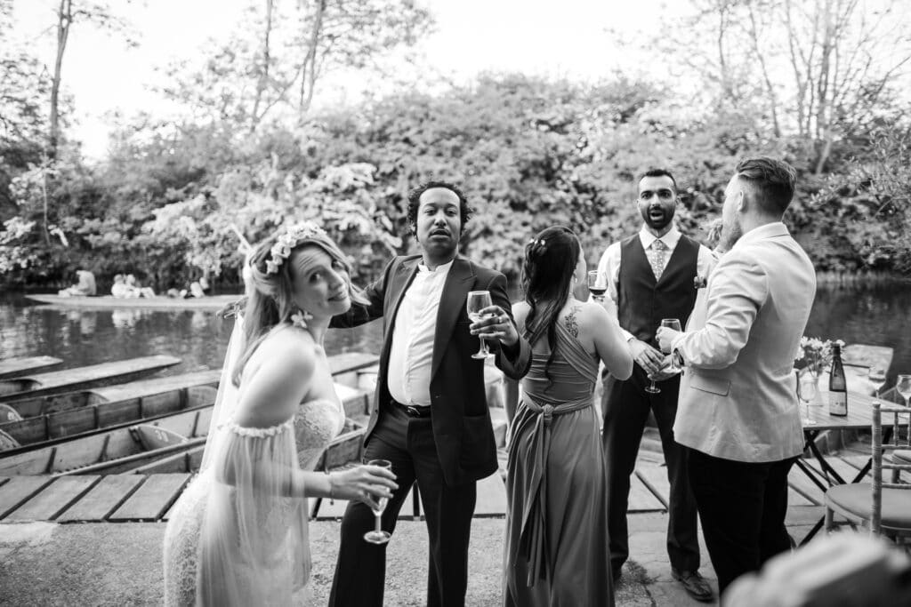 Wedding Guests and Bride having fun at the Cherwell Boathouse with the Cherwell and punts in the background.
