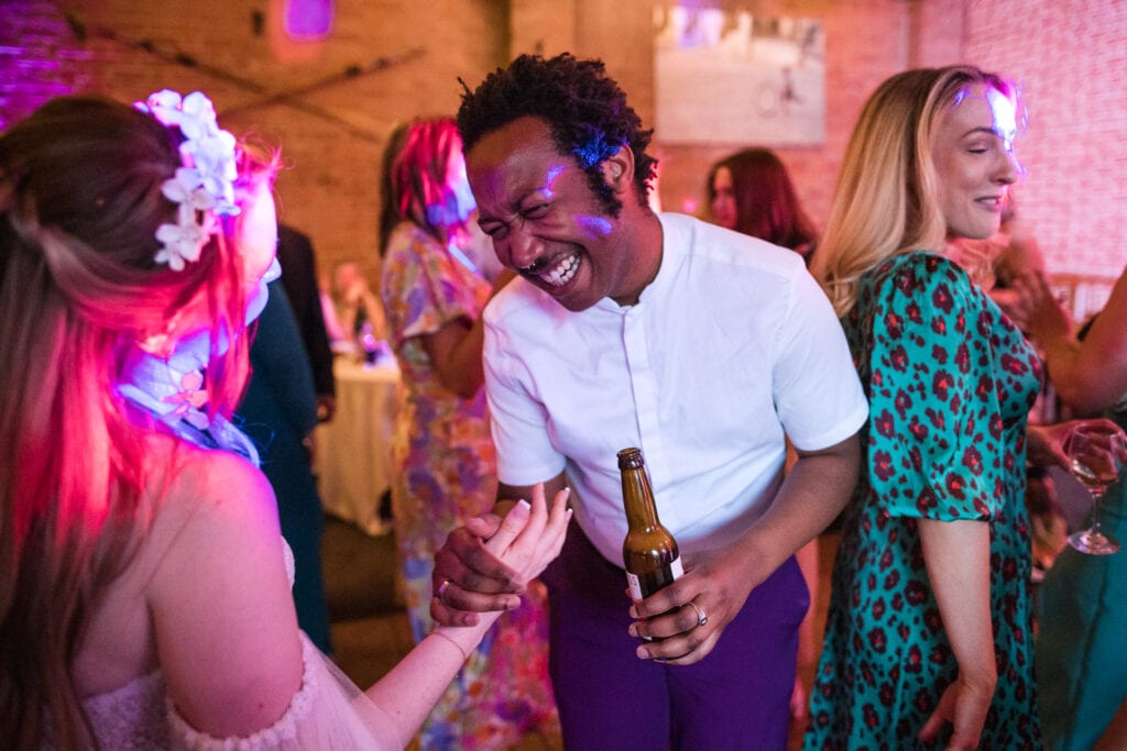 Wedding guest congratulating the bride on the dance floor.