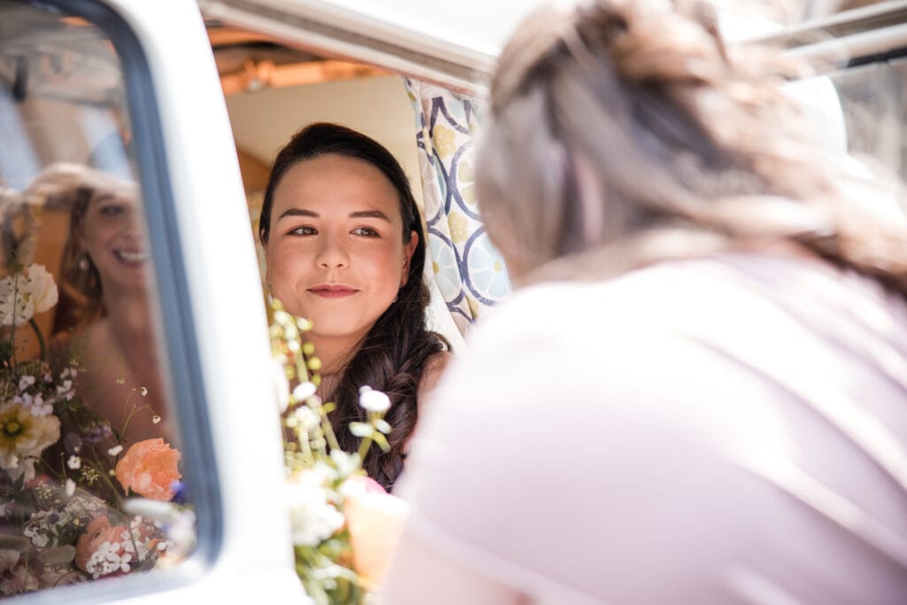 Bridesmaid getting out of the Campervan in the centre of Oxford