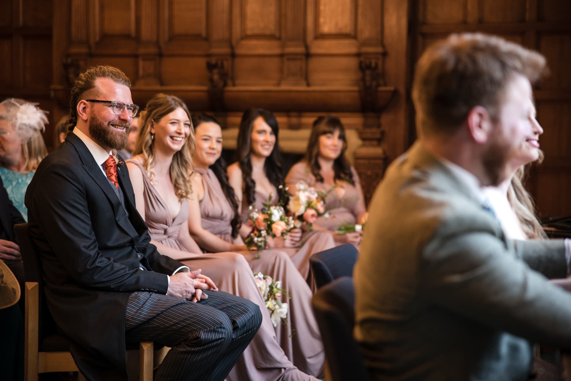 Brides best friend and Bridesmaids looking on during wedding ceremony at Oxford County Hall