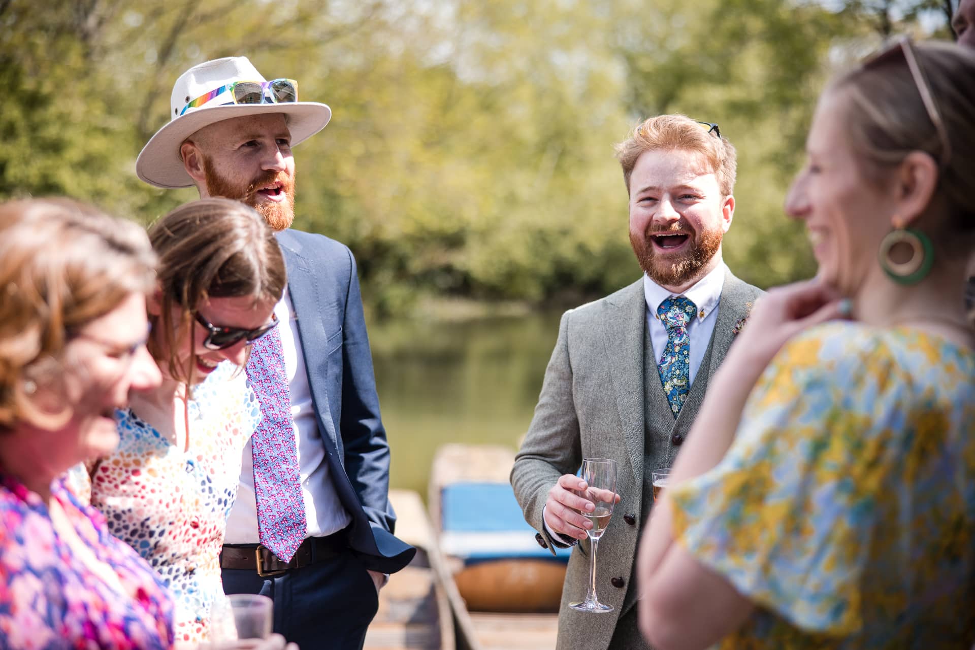 Groom and Guests in conversation at the Cherwell Boathouse