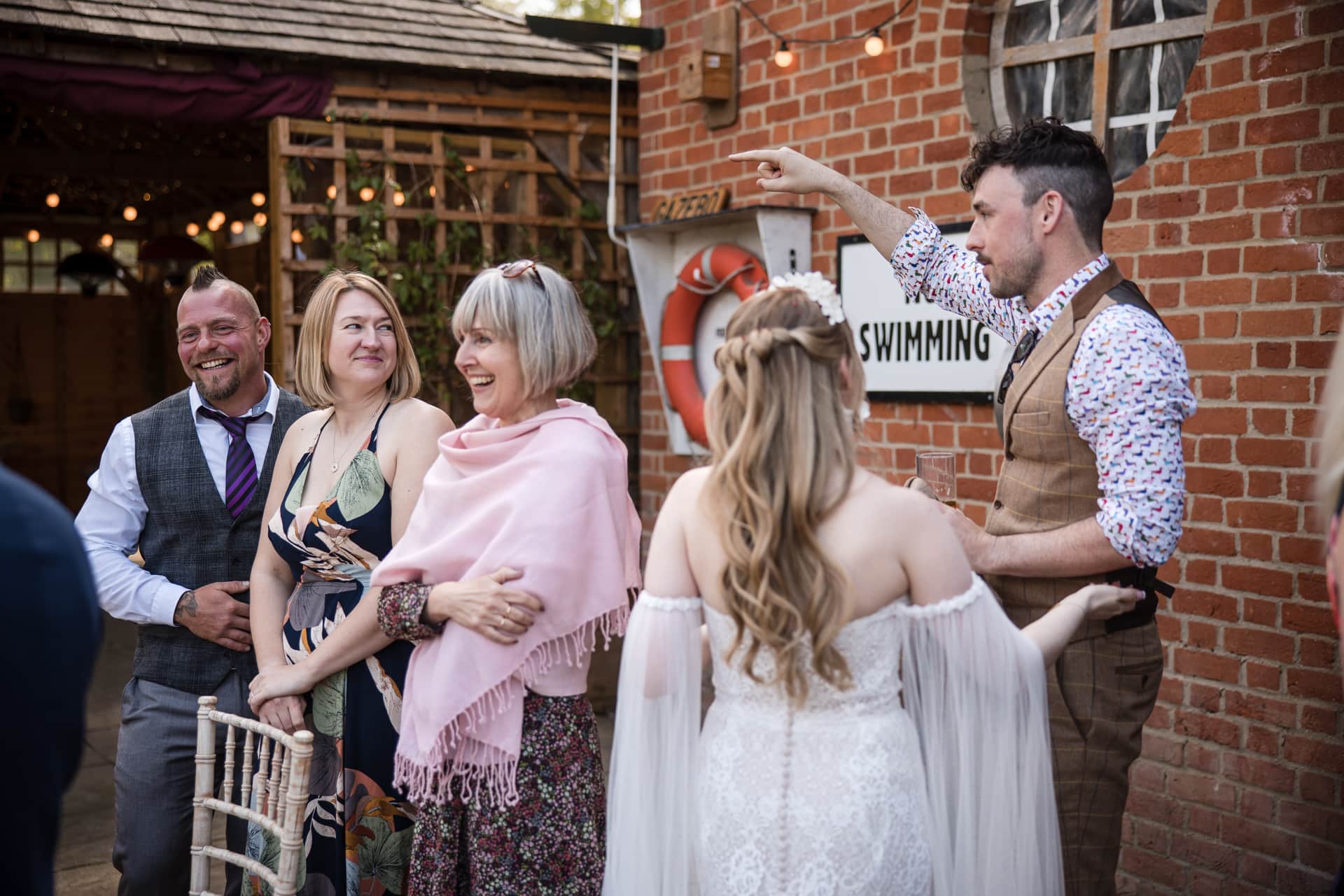 Wedding Guests smiling and laughing at the Cherwell Boathouse