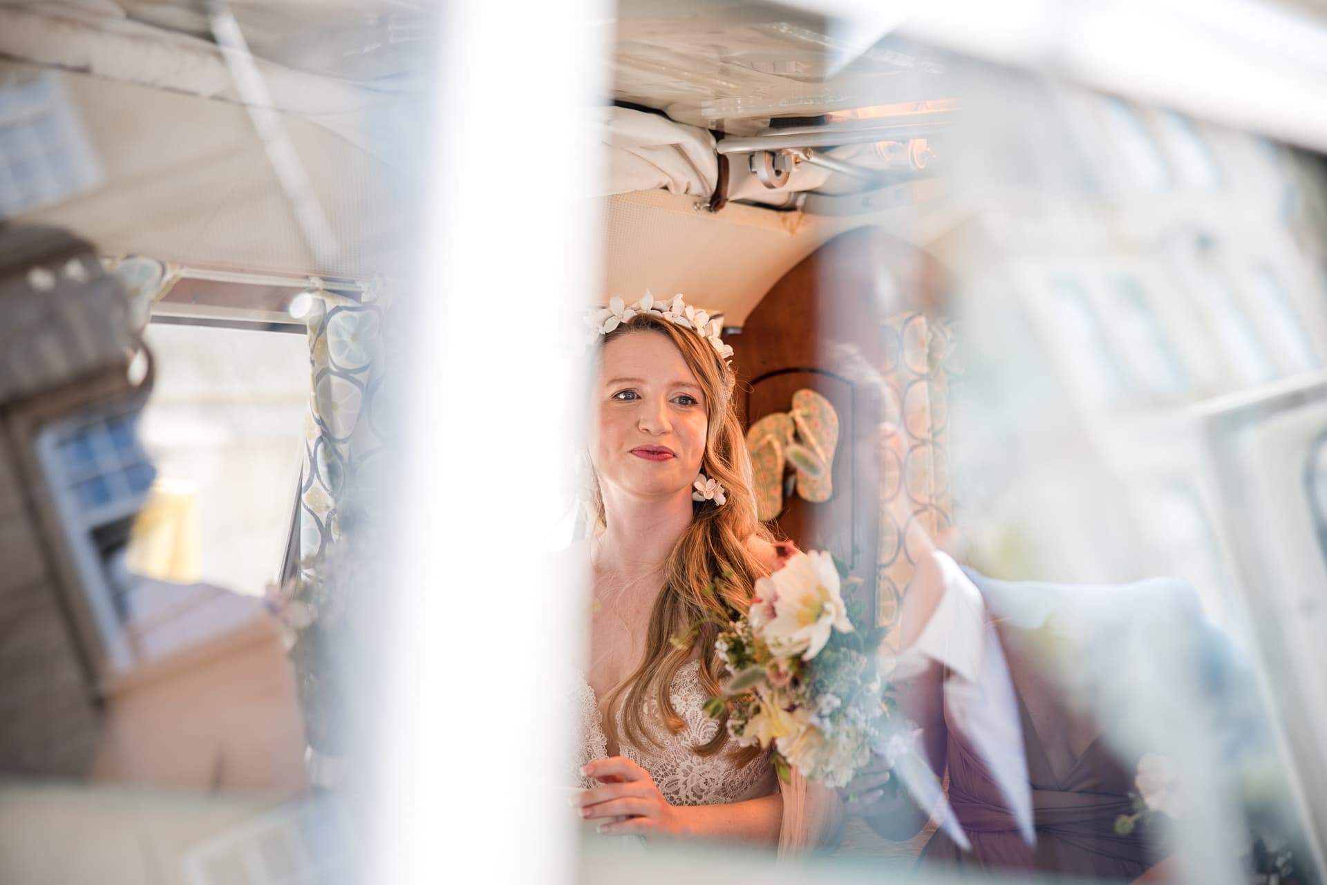 Bride looking out the door of a campervan