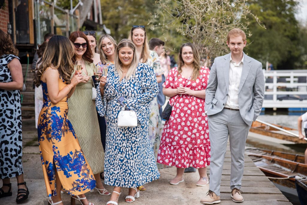 Wedding guests walking alongside the punts at Cherwell Boathouse