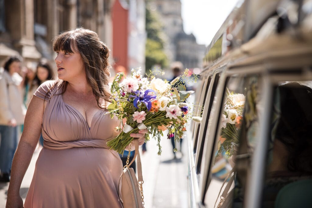 Bridesmaid standing next to the campervan in Oxford
