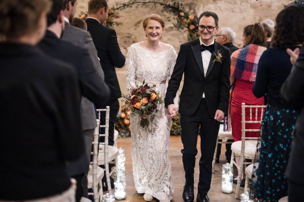 Bride and Groom walking down the aisle at the Crown and Thistle.