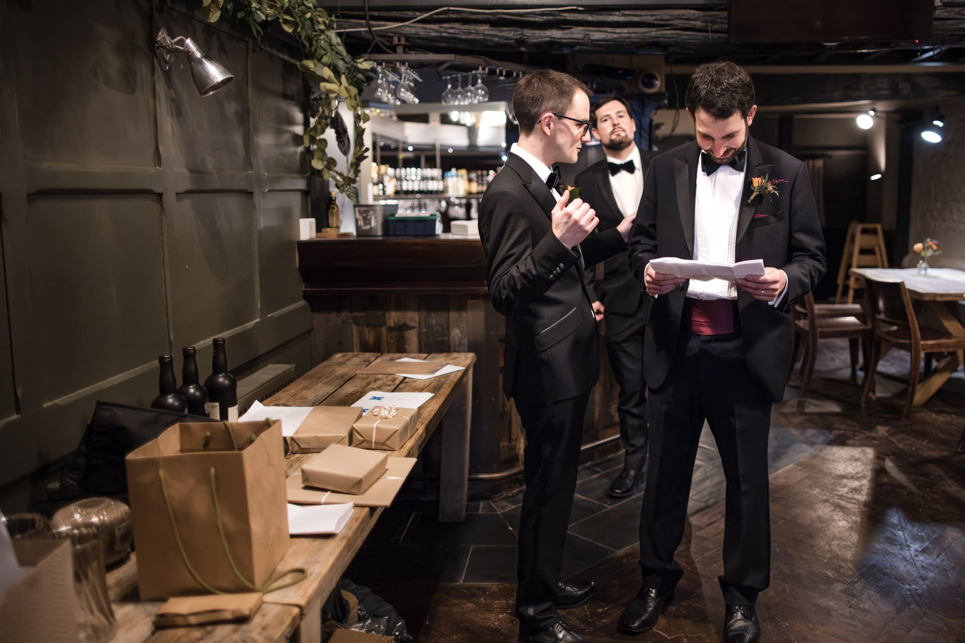 Groom and Groomsmen reviewing speech in the bar
